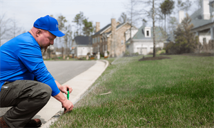 A Conseva Technician Working On Installing A Sprinkler System