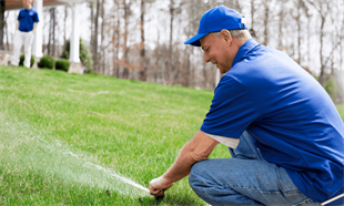 Technician Working On A Sprinkler Repair