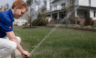 Young Technician Working On A Sprinkler