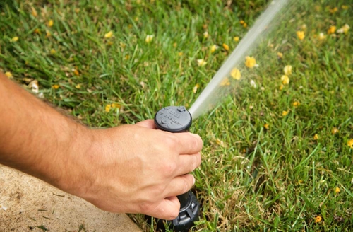 man fixing sprinkler head hampton roads