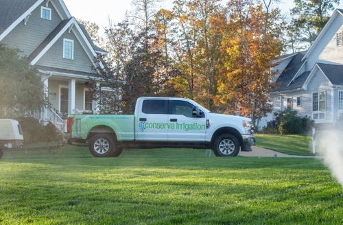 Sprinkler in the front yard in the grass