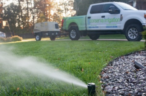 Sprinkler in the front yard in the grass