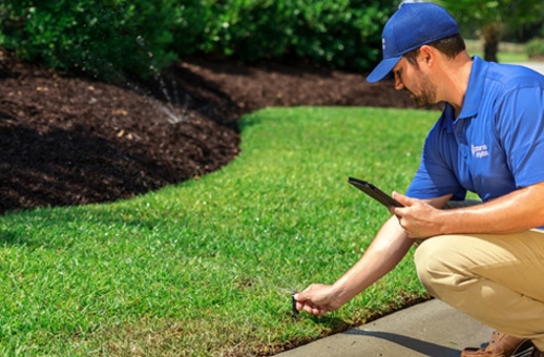 technician setting up sprinkler system