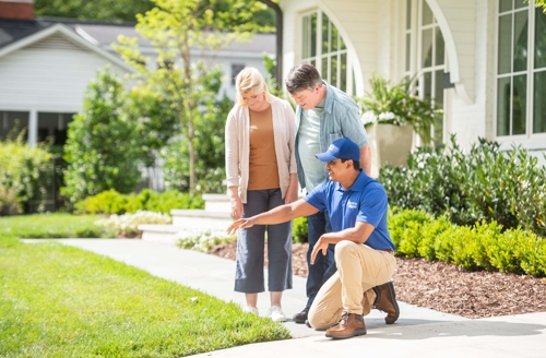people reviewing sprinkler system and yard