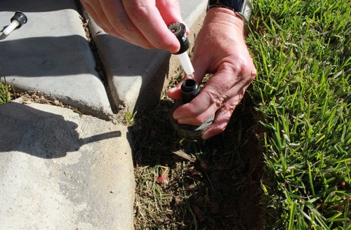 Conserva Irrigation specialist repairing sprinkler head