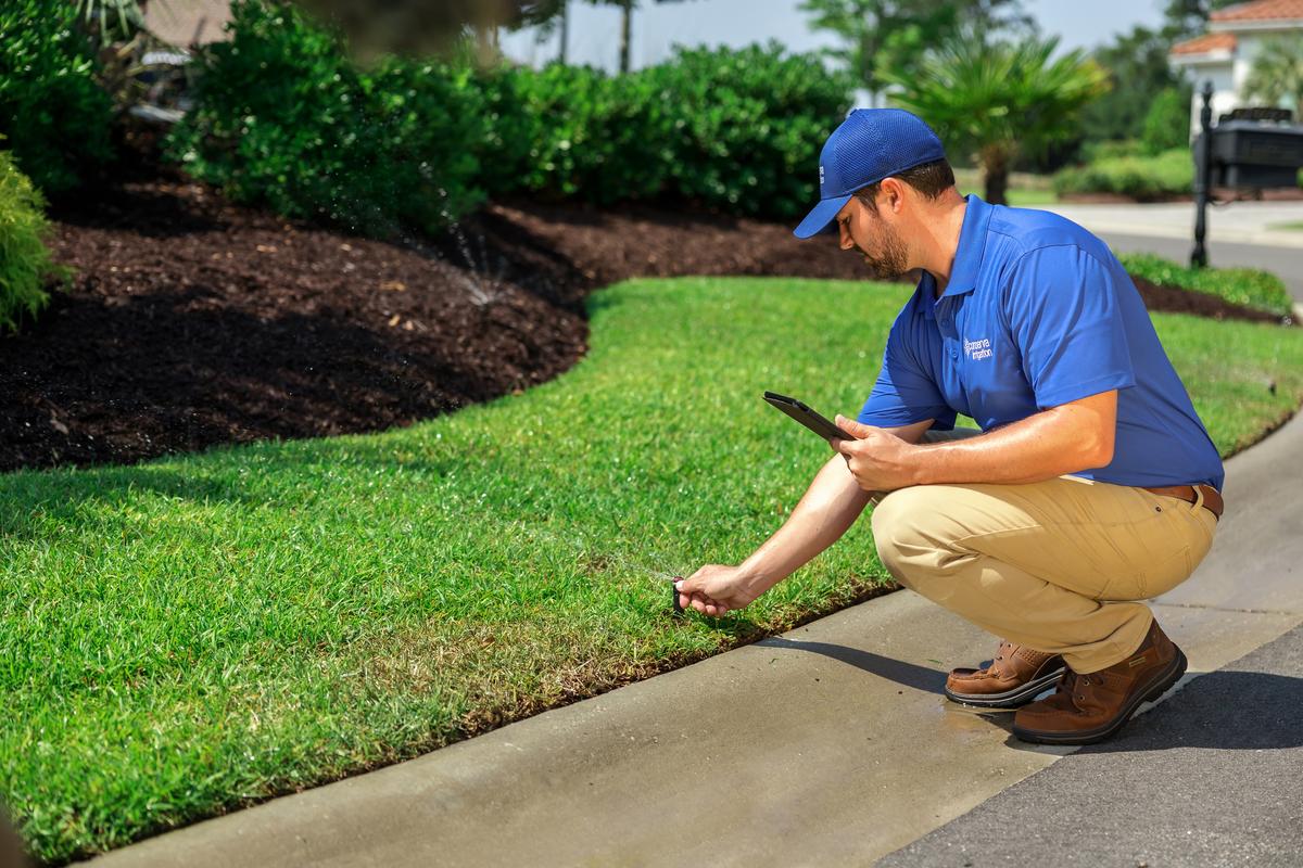 Conserva Tech Inspecting Lawn Irrigation