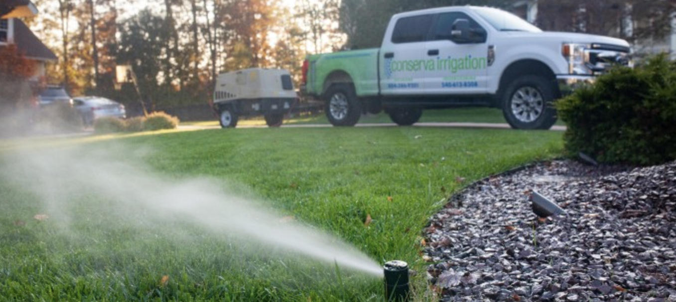 Sprinkler in the front yard in the grass