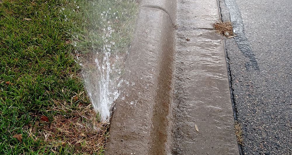 broken sprinkler flooding street in Fort Lauderdale