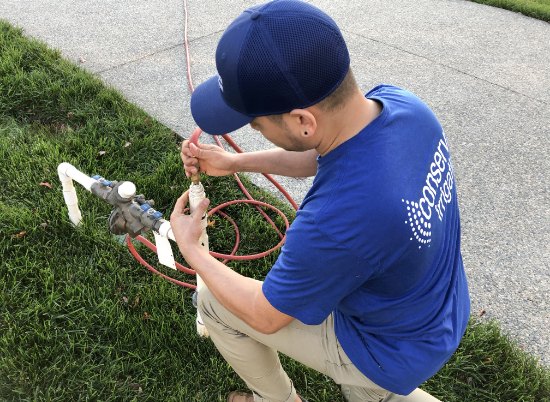 Technician testing the backflow set up of a irrigation system