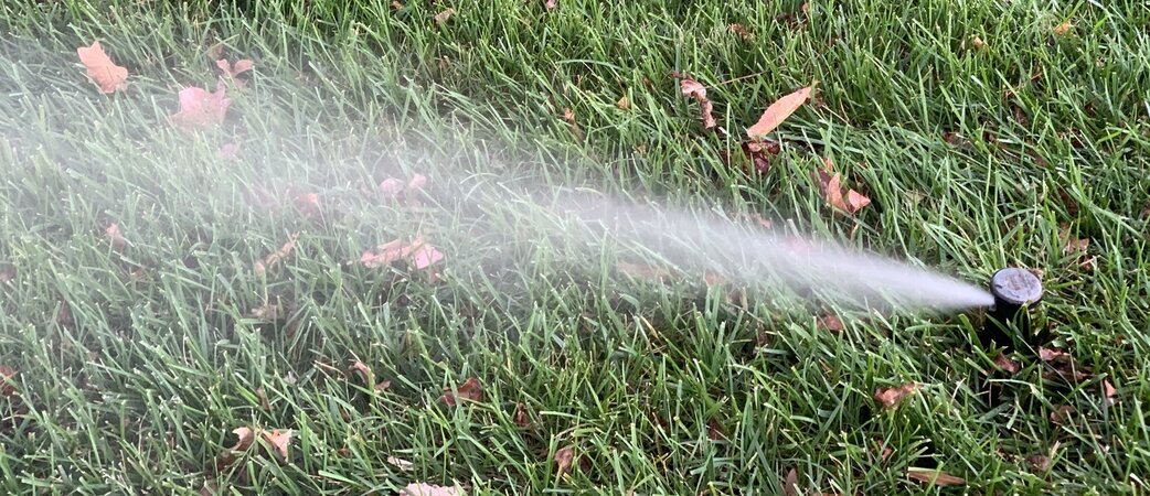 Sprinkler system running in yard