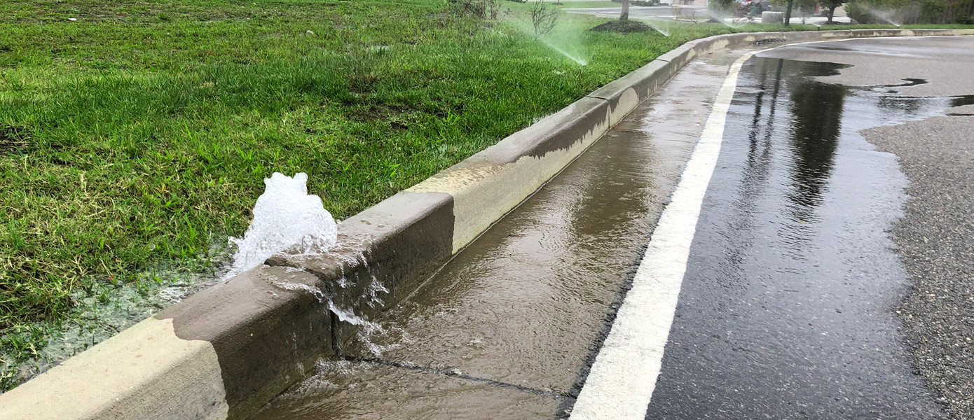 water bubbling out of curb